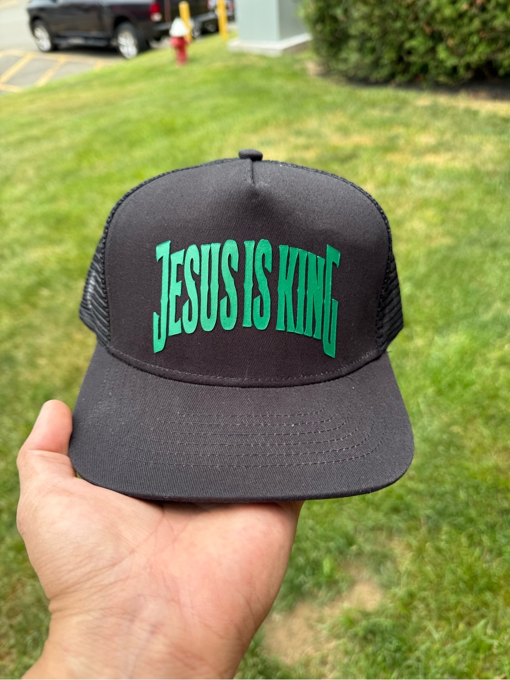 Black Trucker Hat with Green "Jesus Is King" Graphic